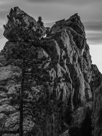Low angle view of rocky mountains against sky