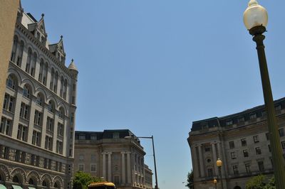 Low angle view of buildings against clear blue sky