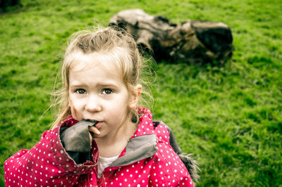 High angle view of girl standing on grassy field