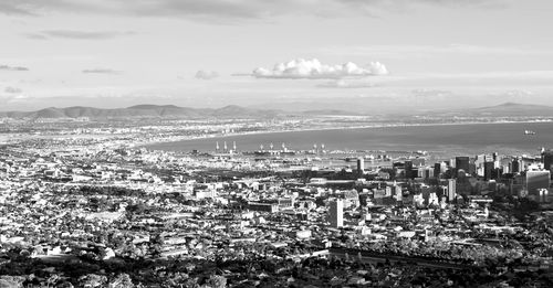 High angle view of city by sea against sky