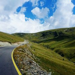 Empty road with mountains in background