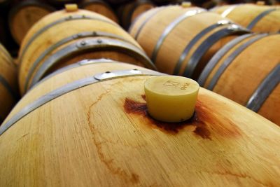 Close-up of wine barrels in winery