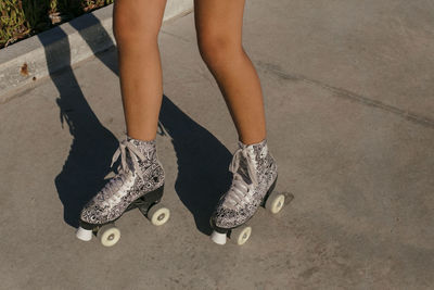 Low section of woman skating on footpath