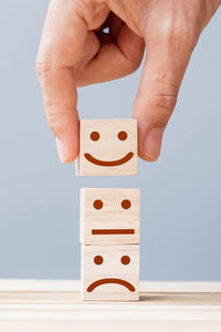 Midsection of person playing with toy against gray background