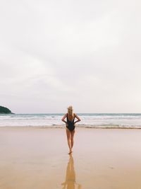 Rear view of man standing on beach