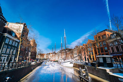 Boats in canal in city