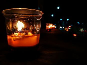 Close-up of illuminated wineglass on table