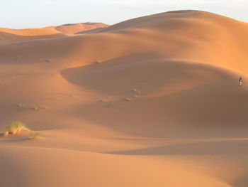 Scenic view of desert against sky during sunset