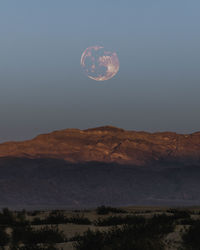 Scenic view of mountains against sky at night