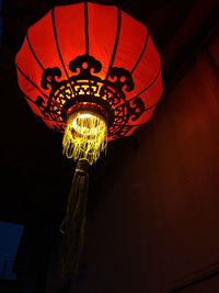 Low angle view of illuminated lantern hanging outdoors