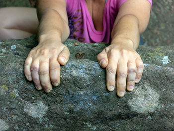 Midsection of woman on rock