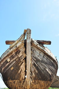 Low angle view of abandoned ship against sky