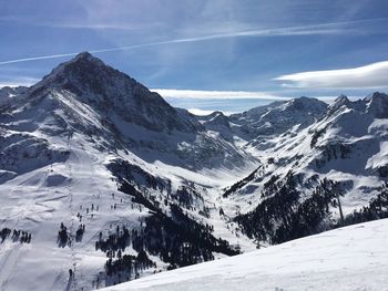 Scenic view of snow covered mountains against sky