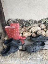 High angle view of shoes on stone wall