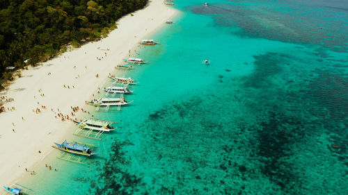 Sandy tropical beach with tourists and blue clear sea. summer and travel vacation concept. boracay