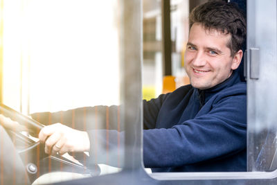 Low section of man standing by window