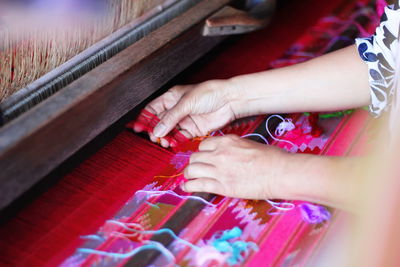 High angle view of woman working on textile in factory