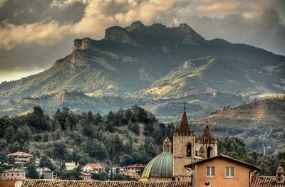 High angle view of townscape by mountains against sky