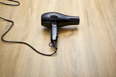 High angle view of hair dryer on wooden table