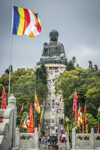 Low angle view of statue against trees and sky