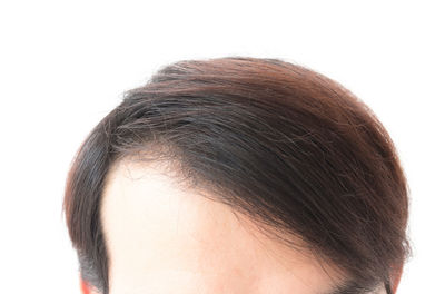 Close-up of woman against white background