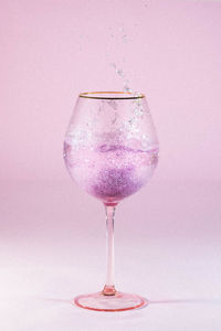 Close-up of wine in glass against white background