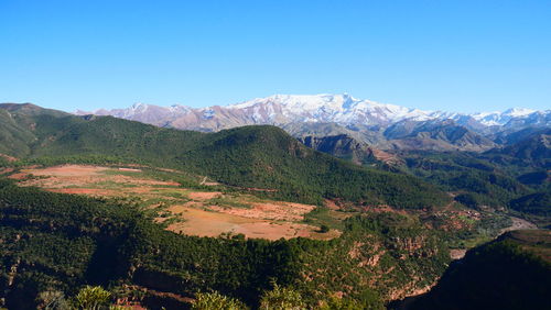 Scenic view of mountains against clear blue sky