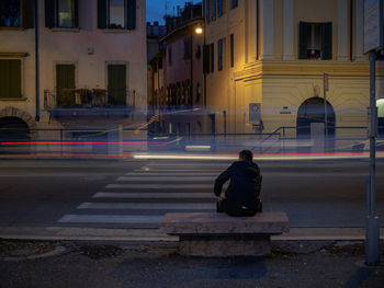 Full length of woman standing in illuminated city at night