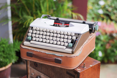 Close-up of typewriter on table outdoors