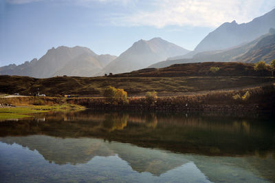 Scenic view of lake and mountains against sky