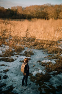 Woman standing on field during winter