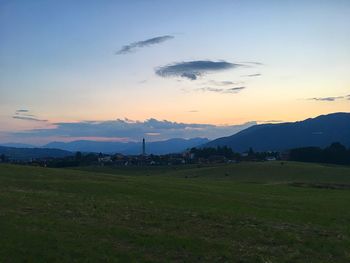 Scenic view of field against sky during sunset