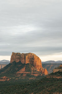 Capital butte rock lit up at sunset as seen from cathedral rock in sedona.