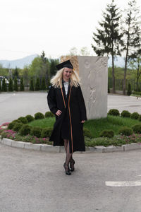 Portrait of woman standing on road