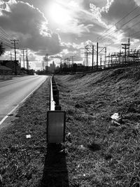 Railroad tracks on field against sky