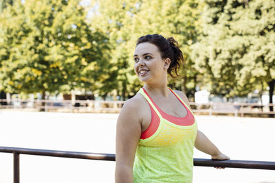 Sporty young woman relaxing in public park