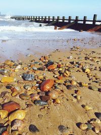 View of pebbles on beach against sky