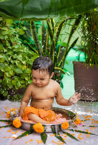 High angle view of shirtless boy in swimming pool