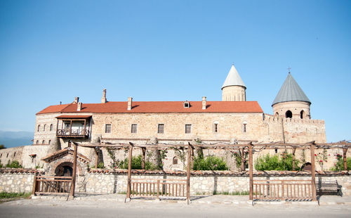 Exterior of old building against clear blue sky