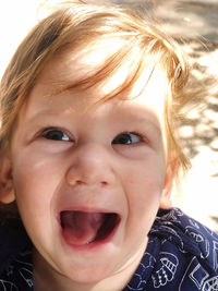 Close-up of boy making face outdoors