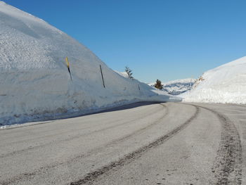 Scenic view of snowcapped mountain against clear blue sky