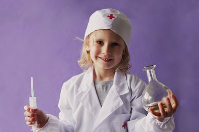 Portrait of smiling boy holding bottle