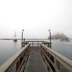 View of jetty in sea against clear sky