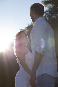 Side view of man standing against sky