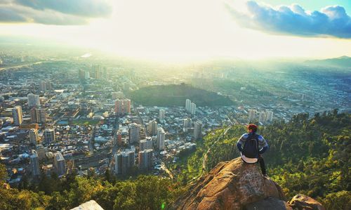 People standing on mountain by sea against sky