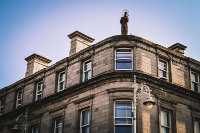 Low angle view of building against blue sky