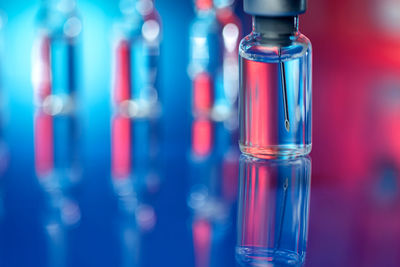 Close-up of glass bottle against blue background