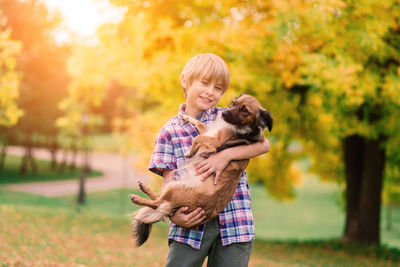 Side view of woman with dog on field