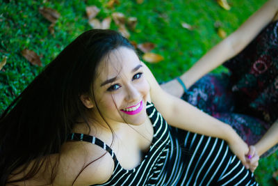 Beautiful young woman lying on grass