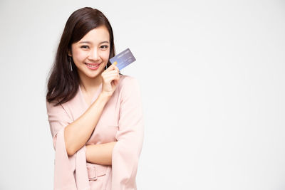 Portrait of a smiling young woman over white background